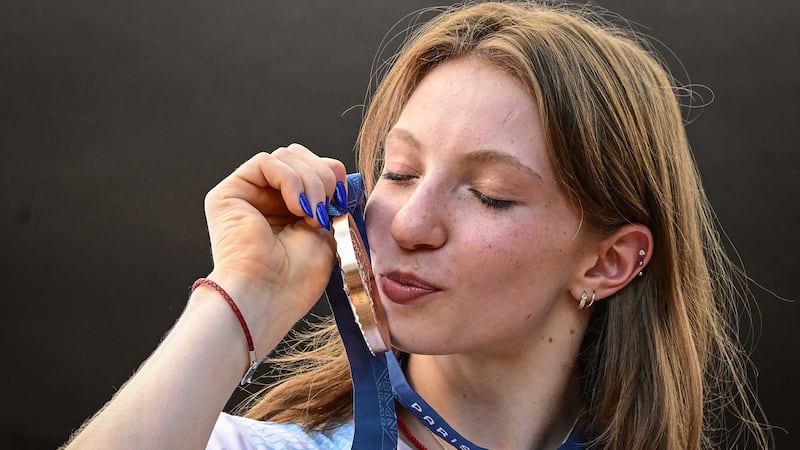 Ana Barbosu kisses her Olympic bronze medal, awarded to her on August 16, 2024.  