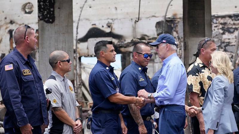 President Joe Biden and first lady Jill Biden greet first responders as they visit areas...