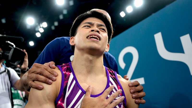 FILE - Carlos Edriel Yulo, of the Philippines, reacts after competing during the men's...