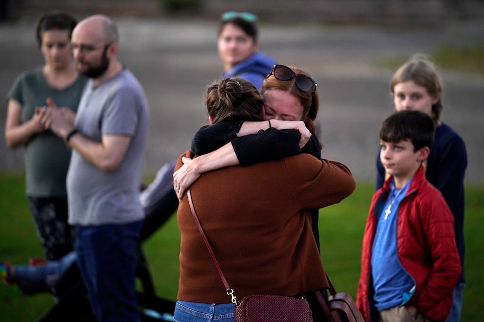 FILE — Lindsay Marlow, facing camera, hugs Courtney Majoros, Oct. 28, 2023, at a vigil in...