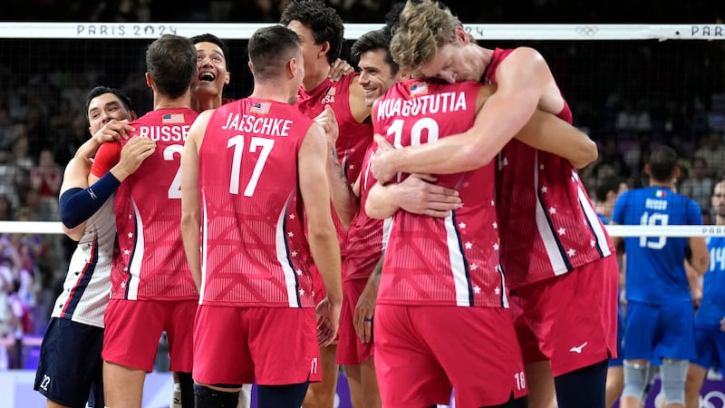 Unites States players celebrate after winning a men's volleyball bronze medal match against...