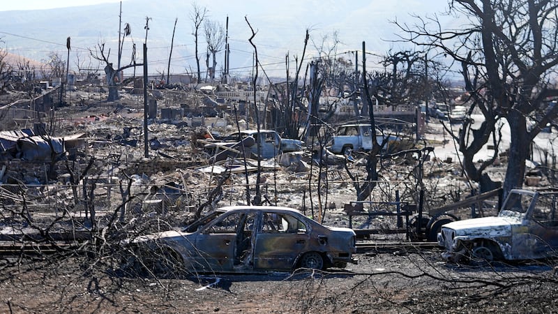 Destroyed homes and cars are shown, Sunday, Aug. 13, 2023, in Lahaina, Hawaii. Hawaii...