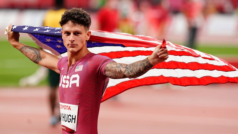 Nick Mayhugh holds an American flag