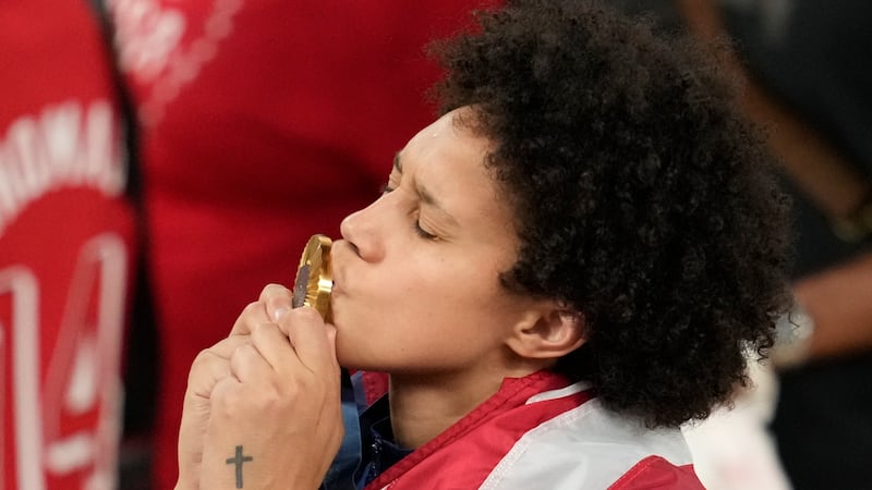 United States' Brittney Griner kisses her gold medal at Bercy Arena at the 2024 Summer...