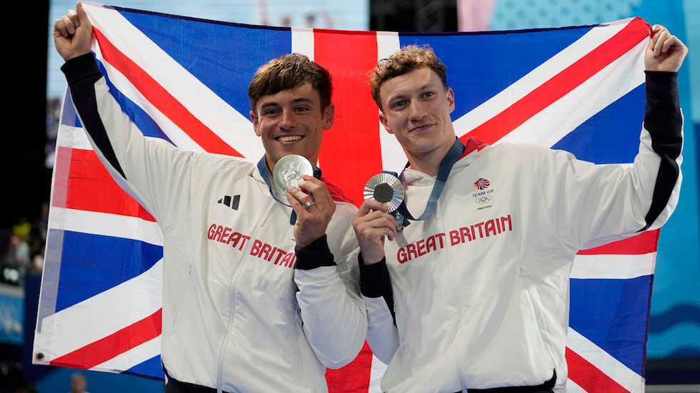 Britain's Thomas Daley and Noah Williams celebrate on the podium after winning the silver...